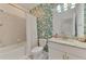 This bathroom features a tropical leafy design with tub and shower combo, plus granite countertop vanity at 1836 W Isles Rd, Port Charlotte, FL 33953