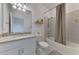 Well-lit bathroom featuring a shower with a bathtub and a vanity with light granite countertops at 1836 W Isles Rd, Port Charlotte, FL 33953
