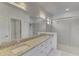 Bathroom with granite countertops, dual sinks, and a glass-enclosed shower at 1836 W Isles Rd, Port Charlotte, FL 33953