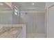 Bathroom features a granite countertop, sink, and glass-enclosed walk-in shower at 1836 W Isles Rd, Port Charlotte, FL 33953