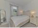 Bright bedroom featuring a decorative headboard, neutral colored walls, and a large window at 1836 W Isles Rd, Port Charlotte, FL 33953