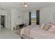 Bedroom featuring a plush bed, window views, and modern decorative accents at 1836 W Isles Rd, Port Charlotte, FL 33953