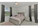 Bedroom with a plush bed, two windows with dark curtains, and neutral decor at 1836 W Isles Rd, Port Charlotte, FL 33953