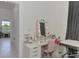 The bonus room features a pink vanity with Hollywood lights, a work table, and storage at 1836 W Isles Rd, Port Charlotte, FL 33953