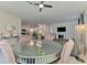Dining area featuring a glass-top table, pink velvet chairs, and a view into the kitchen at 1836 W Isles Rd, Port Charlotte, FL 33953