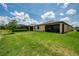 Well-manicured backyard with a screened patio and additional features for outdoor enjoyment at 1836 W Isles Rd, Port Charlotte, FL 33953