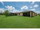 Well-manicured backyard with a screened patio and additional features for outdoor enjoyment at 1836 W Isles Rd, Port Charlotte, FL 33953