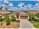 Beautiful home featuring a well-manicured lawn, lush tropical landscaping, and a stylish paved driveway leading to a two-car garage at 1836 W Isles Rd, Port Charlotte, FL 33953