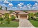 Charming single-story home featuring a well-manicured lawn, paver driveway and a two-car garage at 1836 W Isles Rd, Port Charlotte, FL 33953