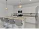 Modern kitchen island with granite countertops and seating for four at 1836 W Isles Rd, Port Charlotte, FL 33953
