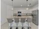 Bright kitchen features a kitchen island with seating and stainless steel appliances at 1836 W Isles Rd, Port Charlotte, FL 33953