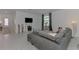 Open-concept living room with tile floors, modern decor, and plenty of natural light at 1836 W Isles Rd, Port Charlotte, FL 33953