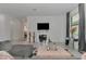 Open-concept living room with tile floors, modern decor, and plenty of natural light at 1836 W Isles Rd, Port Charlotte, FL 33953