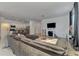 Comfortable living room features an electric fireplace and seamlessly connects to a modern white kitchen at 1836 W Isles Rd, Port Charlotte, FL 33953