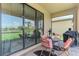 Cozy screened patio with comfortable seating, ideal for relaxing and enjoying the outdoor scenery at 1836 W Isles Rd, Port Charlotte, FL 33953
