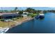 This aerial view features a waterfront property with a pool and boat lift for easy boat storage at 18451 Goodman Cir, Port Charlotte, FL 33948