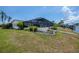 Spacious backyard featuring a pool and waterfront access, ideal for outdoor living at 18451 Goodman Cir, Port Charlotte, FL 33948