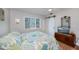 Cozy bedroom with natural light, equipped with a barn-door, closet, and dresser with a mounted television at 18451 Goodman Cir, Port Charlotte, FL 33948