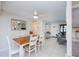 A dining room with a wooden table, white chairs, and tile floors at 18451 Goodman Cir, Port Charlotte, FL 33948