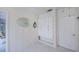 Bright and airy entryway featuring ample storage cabinets, tile floors, and neutral decor at 18451 Goodman Cir, Port Charlotte, FL 33948