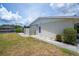 Exterior view of a property with well-kept landscaping and canal access, including a boat lift at 18451 Goodman Cir, Port Charlotte, FL 33948