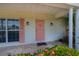 Inviting front entrance with a decorative door, brick facade, and manicured garden at 18451 Goodman Cir, Port Charlotte, FL 33948