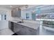 The renovated kitchen has granite counters, grey cabinets and stainless appliances at 18451 Goodman Cir, Port Charlotte, FL 33948
