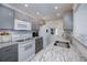 The renovated kitchen has granite counters, grey cabinets and stainless appliances at 18451 Goodman Cir, Port Charlotte, FL 33948
