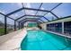 Enclosed pool area features a large pool surrounded by ample patio space for outdoor relaxation at 18451 Goodman Cir, Port Charlotte, FL 33948