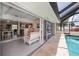 Inviting screened lanai overlooks the pool with convenient access to the indoor and outdoor living spaces at 18451 Goodman Cir, Port Charlotte, FL 33948