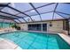 Inviting screened-in pool with tile surround, perfect for relaxation and outdoor enjoyment at 18451 Goodman Cir, Port Charlotte, FL 33948