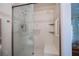 Shower space boasts tiled walls, bench seating, and grab bars to prioritize safety and convenience at 18451 Goodman Cir, Port Charlotte, FL 33948