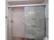 Tiled shower with grab bars and a sliding glass door, offering a safe and accessible bathing experience at 18451 Goodman Cir, Port Charlotte, FL 33948