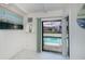 Bright sunroom with tile floor features views of the screened pool and access to the backyard at 18451 Goodman Cir, Port Charlotte, FL 33948