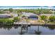 Waterfront home with pool, screened-in lanai, private dock, boat lift, and lush landscaping for serene outdoor living at 18790 Countryman Ave, Port Charlotte, FL 33948