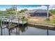 Aerial view highlights the home, dock, and waterside location at 18790 Countryman Ave, Port Charlotte, FL 33948