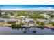 Waterfront home featuring pool, screened lanai, private dock, and boat lift, nestled in a lush, residential neighborhood at 18790 Countryman Ave, Port Charlotte, FL 33948