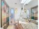 Bright bathroom features granite countertop, skylight, and ocean-themed shower curtain at 18790 Countryman Ave, Port Charlotte, FL 33948
