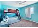 Bedroom with a wooden bunk bed and blue accent wall at 18790 Countryman Ave, Port Charlotte, FL 33948