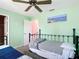 Bedroom featuring two beds, a ceiling fan, mint green walls, and an open closet at 18790 Countryman Ave, Port Charlotte, FL 33948