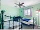 Bright bedroom with two beds, ceiling fan, neutral carpet and soothing mint green walls at 18790 Countryman Ave, Port Charlotte, FL 33948