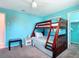 Bedroom showcasing a wooden bunk bed and neutral carpet at 18790 Countryman Ave, Port Charlotte, FL 33948