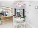 Bright dining area with white table and chairs, adjacent to a kitchen counter at 18790 Countryman Ave, Port Charlotte, FL 33948