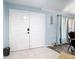 Inviting entryway with double doors, tile flooring, and a glimpse of the living area beyond at 18790 Countryman Ave, Port Charlotte, FL 33948