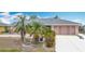 Beautiful single-story home featuring a two-car garage and tropical landscaping with palm trees at 18790 Countryman Ave, Port Charlotte, FL 33948