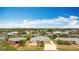 A well-maintained home with a two-car garage and tropical landscaping, surrounded by serene canals at 18790 Countryman Ave, Port Charlotte, FL 33948