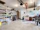 Spacious garage with shelving, storage cabinets, and ample room for vehicles and projects at 18790 Countryman Ave, Port Charlotte, FL 33948