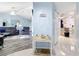 Hallway view that connects the living area with a well-lit kitchen and other rooms in the house at 18790 Countryman Ave, Port Charlotte, FL 33948