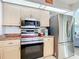 Well-lit kitchen featuring stainless steel appliances, light wood cabinets, and granite countertops at 18790 Countryman Ave, Port Charlotte, FL 33948