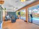 Enclosed lanai with view of the pool, a ceiling fan, and ample seating at 18790 Countryman Ave, Port Charlotte, FL 33948